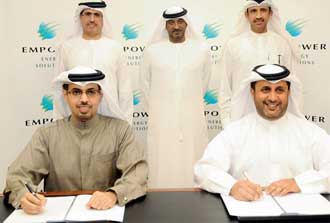 Ahmad bin Shafar and Hamad Buamim signing a deal to create the worlds largest district cooling services provider.